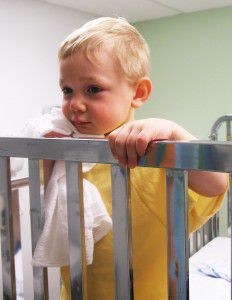 Boy in crib 232x300 Bed wetting: How to help your child stay dry