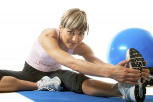 Woman stretching 300x200 Exercise before pregnancy: Yummy Mummies
