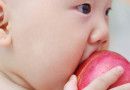 Baby eating apple