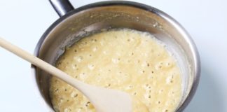 White sauce bubbling in a pot.