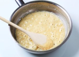 White sauce bubbling in a pot.