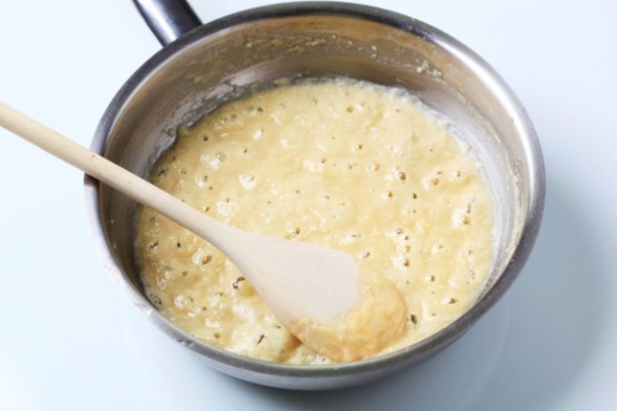 White sauce bubbling in a pot.