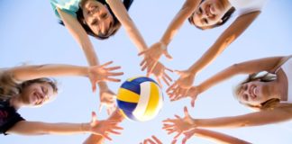 Teenagers playing with volleyball