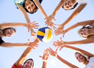 Teenagers playing with volleyball