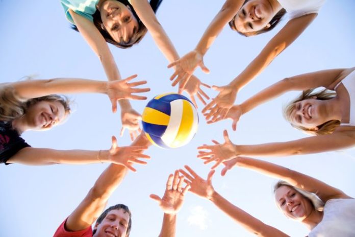 Teenagers playing with volleyball