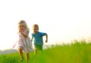 Boy and girl on grassy hill