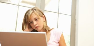 Worried girl using laptop