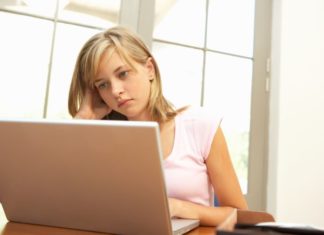 Worried girl using laptop