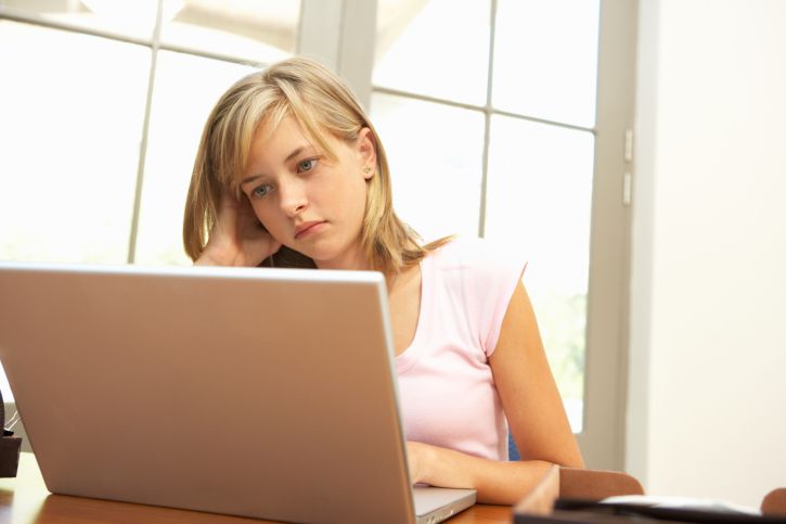 Worried girl using laptop