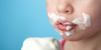 Child with ice cream all over face.