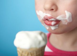 Child with ice cream all over face.