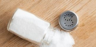 Salt poured from shaker onto table