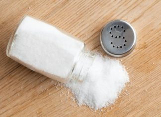 Salt poured from shaker onto table