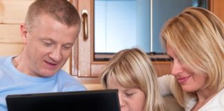 A family uses a laptop.