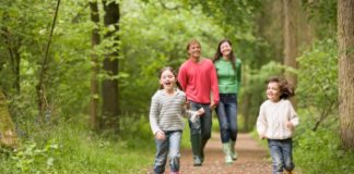 Family walking on path smiling