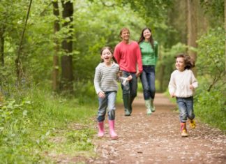 Family walking on path smiling