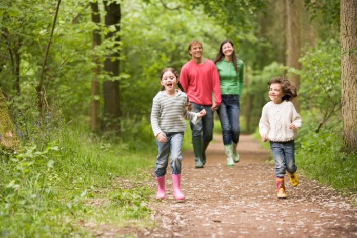 Family walking on path smiling