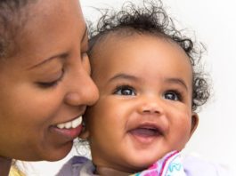 Smiling portrait of mother and daughter.