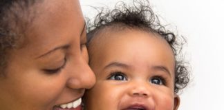 Smiling portrait of mother and daughter.