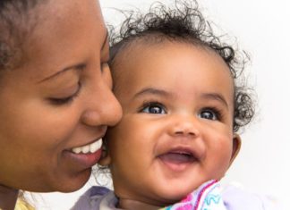 Smiling portrait of mother and daughter.