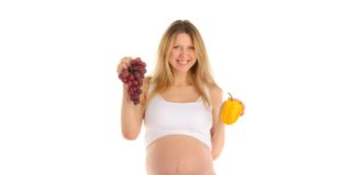 Happy pregnant woman with fruits and vegetables