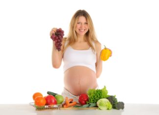 Happy pregnant woman with fruits and vegetables