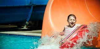 child riding a tube slide