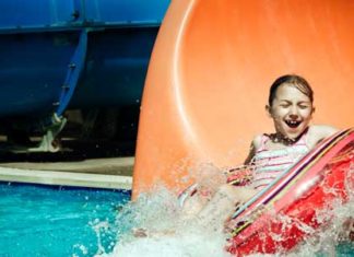 child riding a tube slide