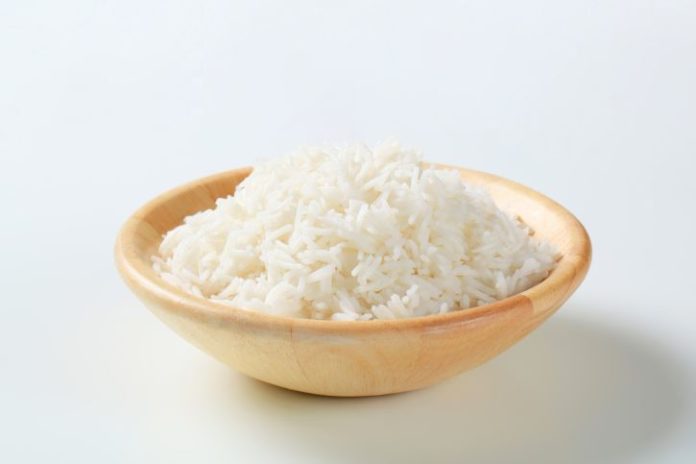 Cooked rice in a wooden bowl.