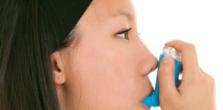 Teen takes her inhaler.