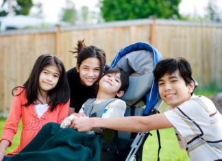 Child in wheelchair with family