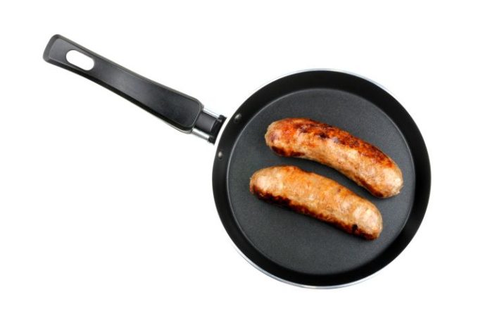 Two sausages in a frying pan.