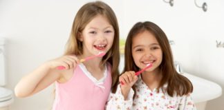 Girls brushing their teeth