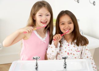 Girls brushing their teeth