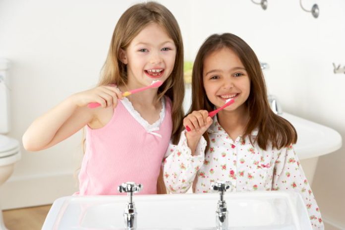 Girls brushing their teeth