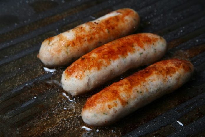 Three sausages sizzling away.