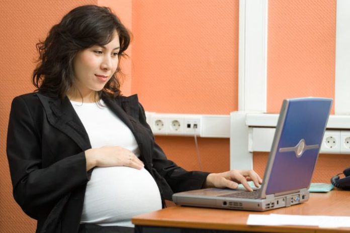 Pregnant woman in office