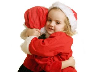 Happy children at Christmas hugging