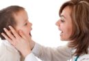 Doctor checking boy’s mouth