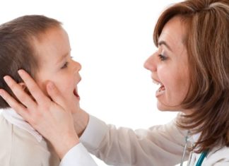 Doctor checking boy's mouth