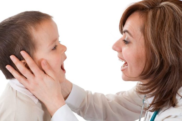 Doctor checking boy's mouth