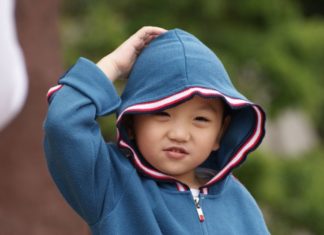 Little boy scratching his head