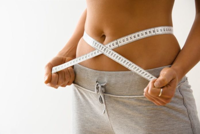 Woman measuring stomach