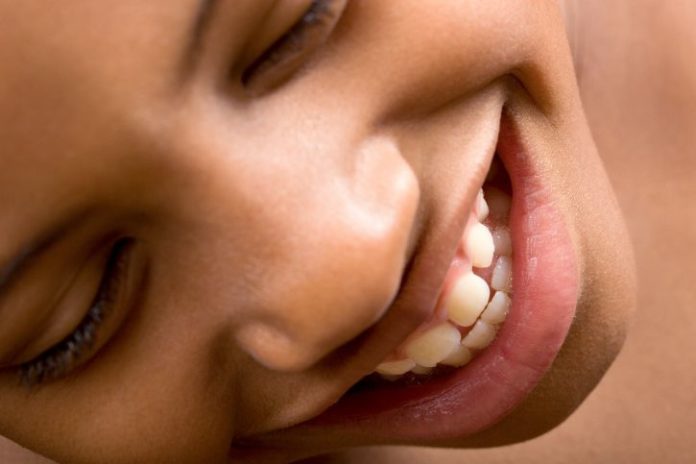 Close up of a girl smiling.