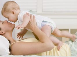 Mother kissing baby