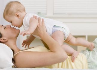 Mother kissing baby