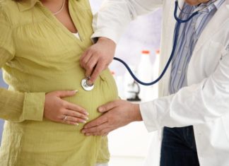 Pregnant woman with doctor