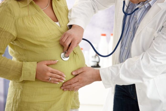 Pregnant woman with doctor