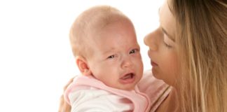 Mum comforting crying baby