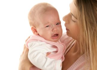 Mum comforting crying baby